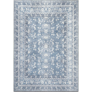 A rectangular rug with a blue background featuring hand-drawn botanical and damask motifs in shades of light and dark blue, and accents of ivory, light grey, and light cream.