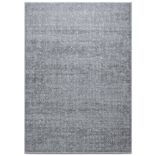 A modern geometric rug in varying shades of grey, featuring a subtle pattern with no distinct geometric shapes.